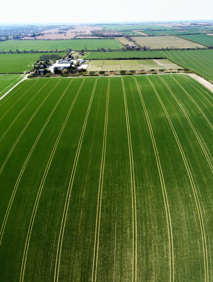 A stunning aerial view of vibrant green farmland in Central Bedfordshire, England.